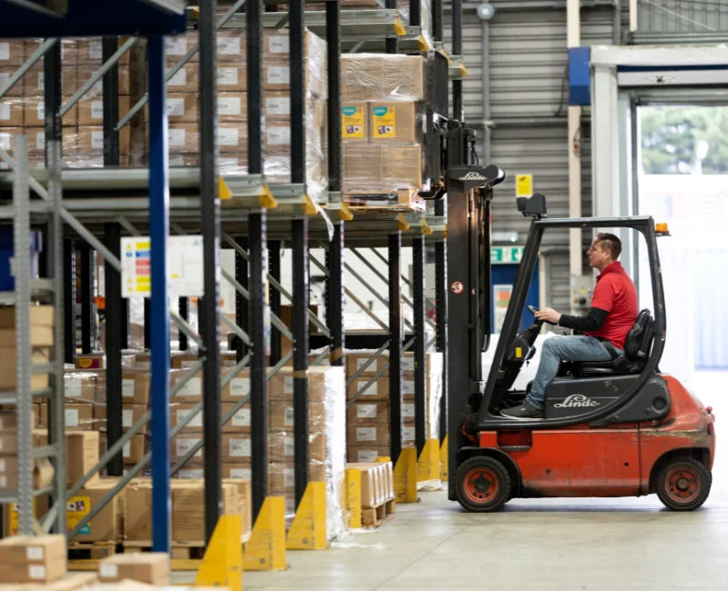 A forklift operator navigates his way around EC Group's warehouse