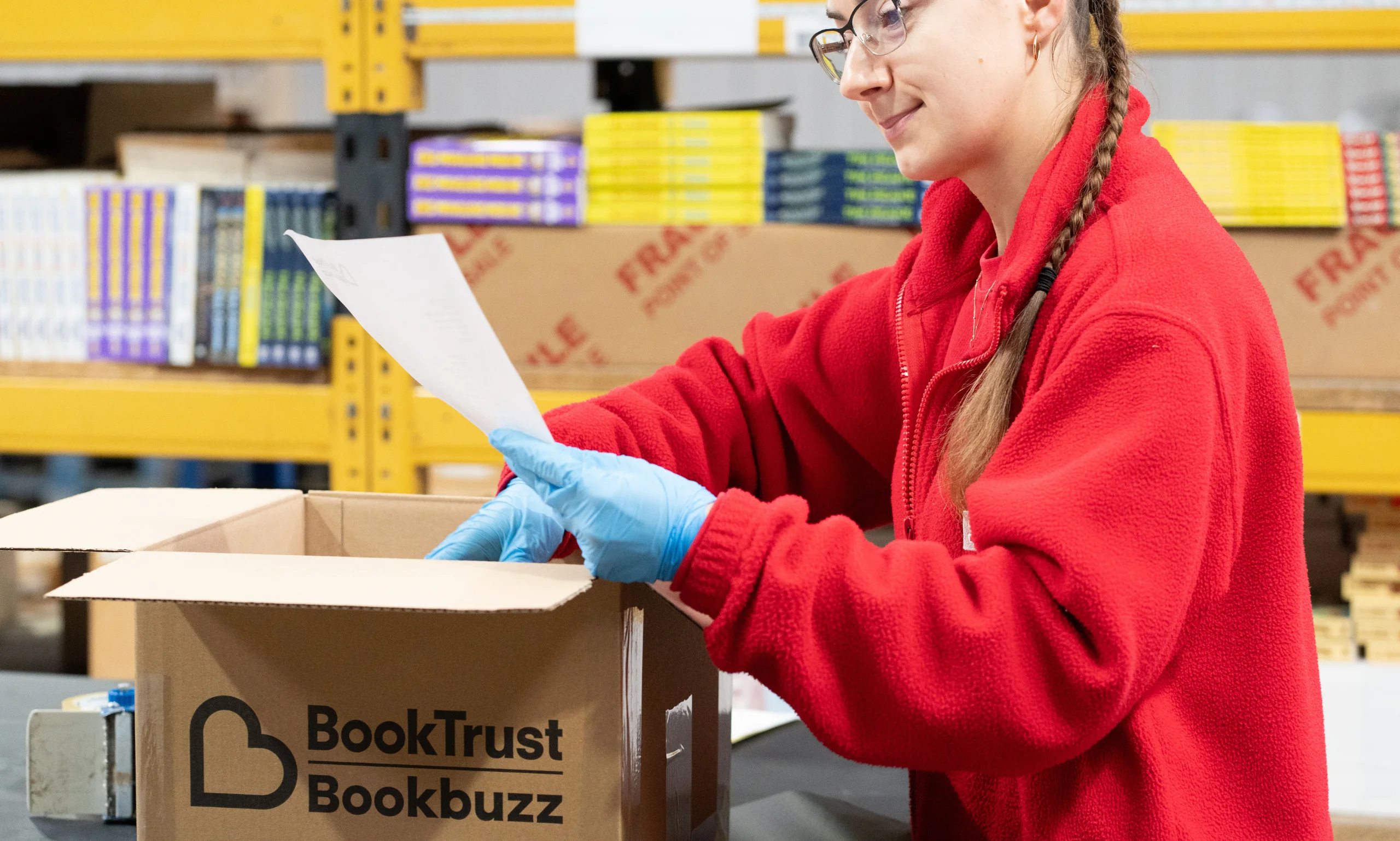 An EC Group employee consults BookTrust conditions for packaging