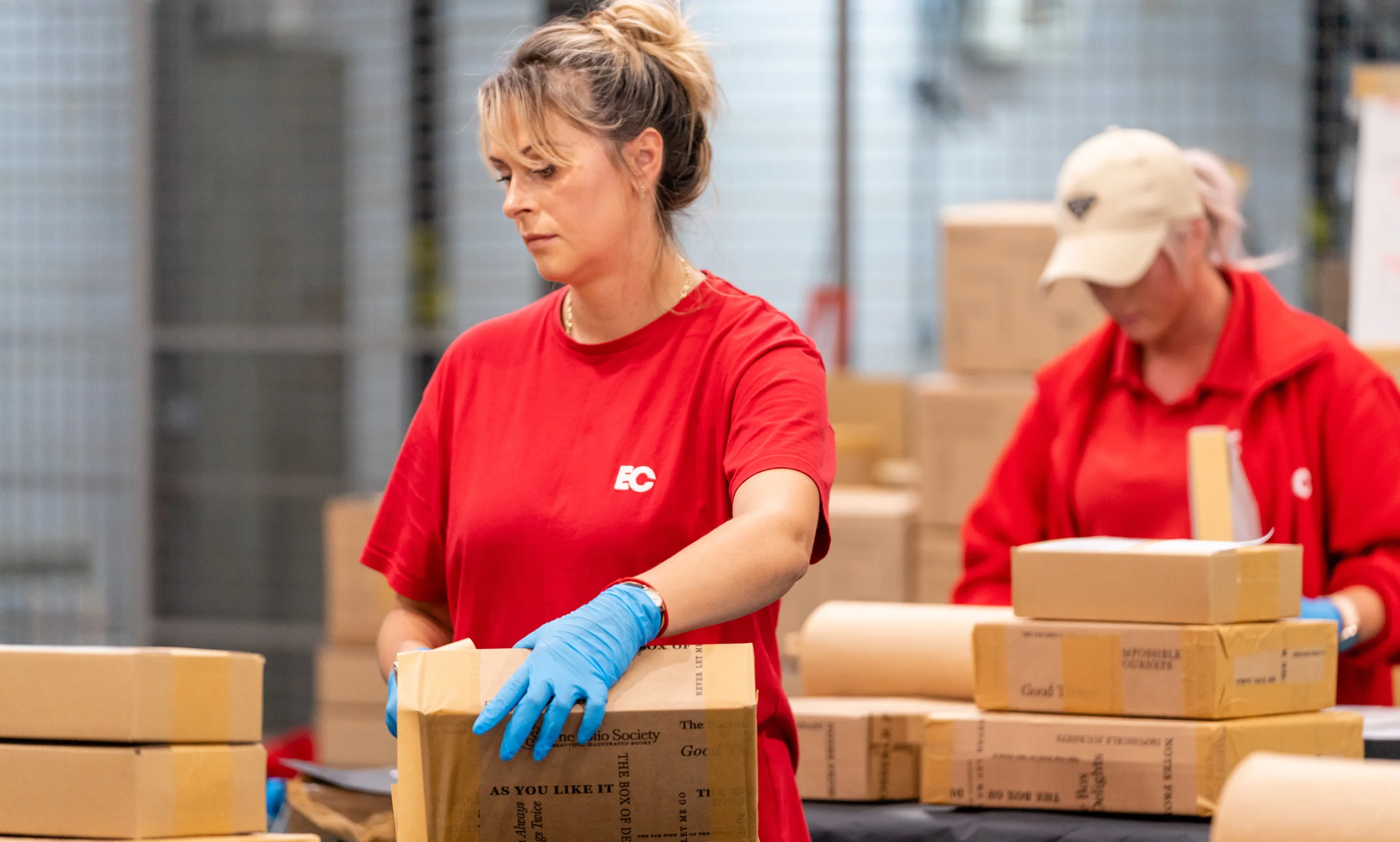 An EC Group employees packages a box for The Folio Society