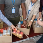 An image of charity workers compiling boxes of food to provide to those in need