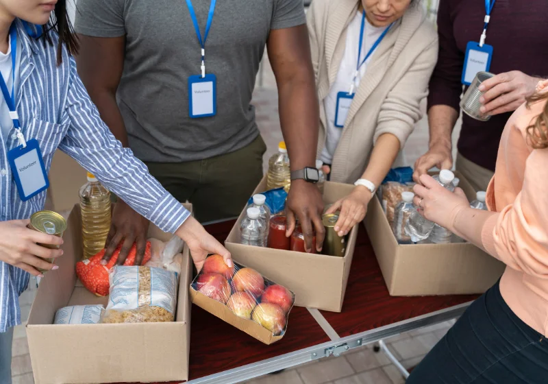 An image of charity workers compiling boxes of food to provide to those in need