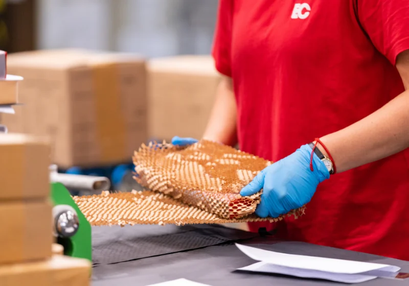 An image of an EC Group employee wrapping a product for The Folio Society