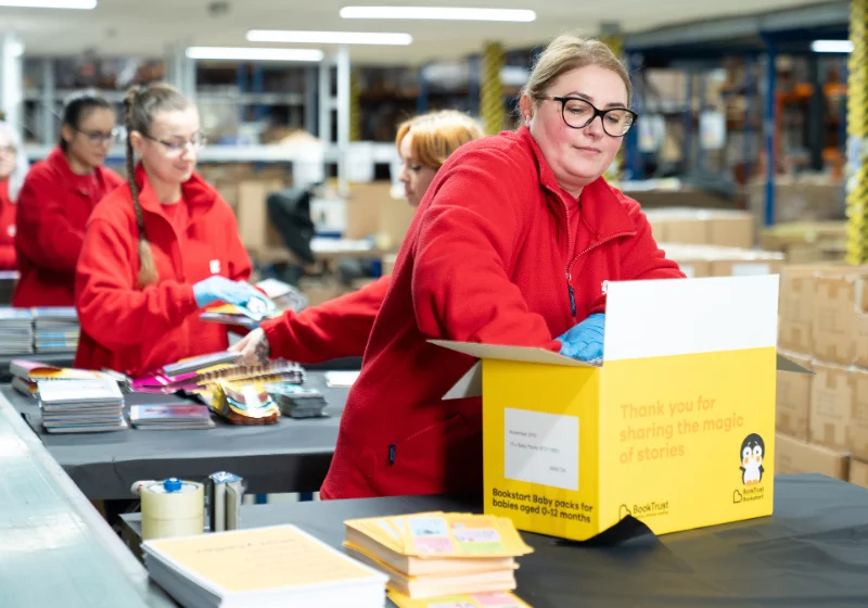 An image of EC Group employees fulfilling a box of goods for BookTrust