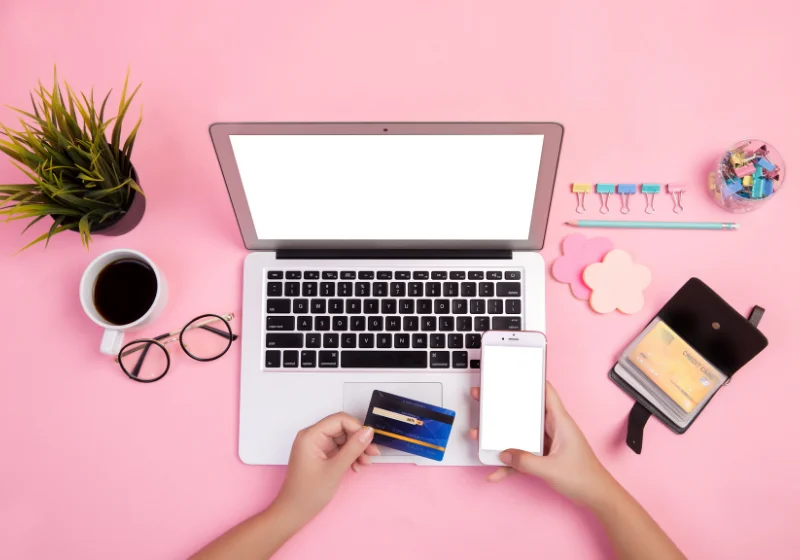 An image of someone transferring the details of their debit card onto their laptop